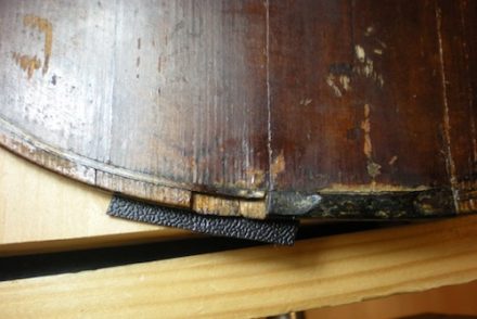 Wood missing on bottom edge of violin top.